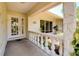 Inviting front porch with stone accents, decorative columns, and a charming glass entryway at 915 S Doral Ln, Venice, FL 34293