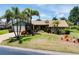 Attractive single-story home with lush greenery, vibrant landscaping, and a well-maintained lawn at 915 S Doral Ln, Venice, FL 34293
