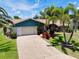 Charming single-story home boasting a two car garage, lush landscaping, and a well-maintained driveway at 915 S Doral Ln, Venice, FL 34293