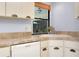 Kitchen area with countertops, white dishwasher, and a view of the pool area at 915 S Doral Ln, Venice, FL 34293
