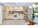 Well-lit kitchen featuring modern appliances, ample cabinet space, and a breakfast nook with scenic views at 915 S Doral Ln, Venice, FL 34293