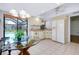 Eat-in kitchen with a glass-topped table, white cabinets, and a view of the pool at 915 S Doral Ln, Venice, FL 34293