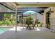 Cozy screened lanai with outdoor seating, perfect for enjoying the poolside view at 915 S Doral Ln, Venice, FL 34293