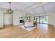 Spacious living room featuring a fireplace, built-in shelving, beamed ceilings, and views of the pool area at 915 S Doral Ln, Venice, FL 34293