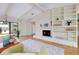 Cozy living room with stone fireplace, built-in shelving, and comfortable seating area at 915 S Doral Ln, Venice, FL 34293