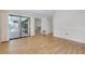 Bright living room featuring wood floors and a large sliding glass door to the lanai at 915 S Doral Ln, Venice, FL 34293