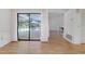 Bright living room featuring wood floors and a large sliding glass door to the pool area at 915 S Doral Ln, Venice, FL 34293