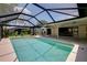 A screened in pool area with outdoor seating and a covered patio at 915 S Doral Ln, Venice, FL 34293