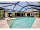A screened in pool area with outdoor seating and a covered patio at 915 S Doral Ln, Venice, FL 34293