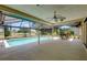 Relaxing outdoor pool area with a screened-in lanai and views of the surrounding landscape at 915 S Doral Ln, Venice, FL 34293