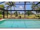 Beautiful pool enclosed by a screen, offering views of the lush green landscape at 915 S Doral Ln, Venice, FL 34293