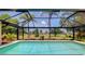 Stunning pool surrounded by a screened enclosure and picturesque landscaping at 915 S Doral Ln, Venice, FL 34293