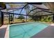 Screened pool with clear water and golf course views beyond at 915 S Doral Ln, Venice, FL 34293