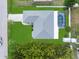 Aerial view of a well-maintained home featuring an outdoor screened pool, and lush green landscaping at 9277 Saint Catherine Ave, Englewood, FL 34224