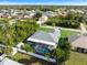 Aerial view of home with screened pool, fenced yard, and a detached garage, perfect for storage or hobbies at 9277 Saint Catherine Ave, Englewood, FL 34224