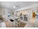 Open dining area flowing into the kitchen, featuring neutral decor, an eat-in bar, and tile flooring throughout at 9277 Saint Catherine Ave, Englewood, FL 34224