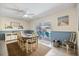 Bright dining room with stylish furniture, wainscoting, and sliding door to the pool area at 9277 Saint Catherine Ave, Englewood, FL 34224