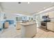 Open kitchen featuring an island, stainless steel appliances, and a view of the connected dining area at 9277 Saint Catherine Ave, Englewood, FL 34224