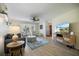 Bright living room featuring wood floors, neutral decor, natural light, and a large bay window seating area at 9277 Saint Catherine Ave, Englewood, FL 34224