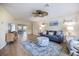 Comfortable living room features wood floors, blue accents, lots of natural light, and views to the screened lanai at 9277 Saint Catherine Ave, Englewood, FL 34224