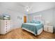 Bright main bedroom with a ceiling fan, wood floors, dresser, and coastal decor at 9277 Saint Catherine Ave, Englewood, FL 34224