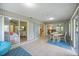 Enclosed sunroom with tiled floors and furniture, connecting indoor and outdoor living spaces at 9277 Saint Catherine Ave, Englewood, FL 34224