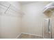 Empty walk-in closet with wood floors, wire shelving, and a full-length mirror, ready for personalized storage at 9277 Saint Catherine Ave, Englewood, FL 34224