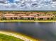 Scenic aerial view capturing the waterfront condos with a tranquil lake in a serene community at 10213 Staggerbush Dr # 202, Venice, FL 34293