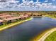 Beautiful aerial view of the condos near the lake with bright blue skies and fluffy clouds at 10213 Staggerbush Dr # 202, Venice, FL 34293