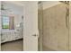 Shower in the main bathroom with tiled wall and clear glass door at 10213 Staggerbush Dr # 202, Venice, FL 34293