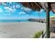 A sandy beach with views of the water and fishing pier offers opportunities for relaxation and enjoyment in Wellen Park at 10213 Staggerbush Dr # 202, Venice, FL 34293