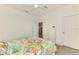 Cozy bedroom showcasing a colorful quilt, white dresser, and access to the closet and bathroom at 10213 Staggerbush Dr # 202, Venice, FL 34293
