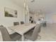 Stylish dining room that transitions to the kitchen featuring an open floor plan concept and modern decor at 10213 Staggerbush Dr # 202, Venice, FL 34293