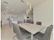 Open dining room and kitchen concept featuring modern lighting and sleek decor for easy entertaining at 10213 Staggerbush Dr # 202, Venice, FL 34293