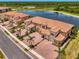 Aerial view of a multi-Gathering house, showcasing the well-maintained landscaping and idyllic waterfront location at 10213 Staggerbush Dr # 202, Venice, FL 34293