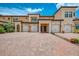 Exterior of a lovely home with a three car garage and a brick driveway and mature landscaping at 10213 Staggerbush Dr # 202, Venice, FL 34293