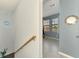 Upstairs hallway leading to a beautifully decorated bedroom with large windows at 10213 Staggerbush Dr # 202, Venice, FL 34293