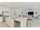 Open concept kitchen with stainless steel appliances and a spacious island that opens up to a living area at 10213 Staggerbush Dr # 202, Venice, FL 34293
