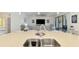 Bright kitchen with an island, stainless steel double sink, modern fixtures, and an open view into the living room at 10213 Staggerbush Dr # 202, Venice, FL 34293