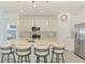 Modern kitchen showcasing a large island with seating, stainless steel appliances, and bright lighting at 10213 Staggerbush Dr # 202, Venice, FL 34293
