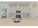 Modern kitchen featuring white cabinets, stainless appliances, and a quartz countertop island with elegant pendant lighting at 10213 Staggerbush Dr # 202, Venice, FL 34293