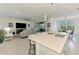 Spacious kitchen with a center island and view into the living room featuring stainless steel appliances at 10213 Staggerbush Dr # 202, Venice, FL 34293