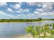 Picturesque lake view showcasing the serene waterfront and lush green surroundings at 10213 Staggerbush Dr # 202, Venice, FL 34293