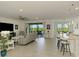 Open-concept living room features large windows with scenic views, tile floors, and a contemporary design at 10213 Staggerbush Dr # 202, Venice, FL 34293