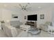 Cozy living room features comfortable seating, a fireplace, and contemporary décor with plenty of natural light at 10213 Staggerbush Dr # 202, Venice, FL 34293