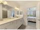 View from the main bathroom into the main bedroom shows a spacious layout and natural light at 10213 Staggerbush Dr # 202, Venice, FL 34293