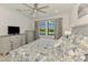 Comfortable main bedroom with tiled floors and a window providing scenic views at 10213 Staggerbush Dr # 202, Venice, FL 34293