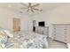 Another view of the main bedroom shows the closet, furnishings, and bathroom entrance at 10213 Staggerbush Dr # 202, Venice, FL 34293