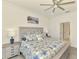 Bright and airy main bedroom with a decorative headboard and a calming coastal painting at 10213 Staggerbush Dr # 202, Venice, FL 34293