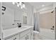 Clean bathroom featuring a single vanity with white countertops, modern lighting, and a shower-tub combination at 10367 Abaco Falls Dr, Englewood, FL 34223